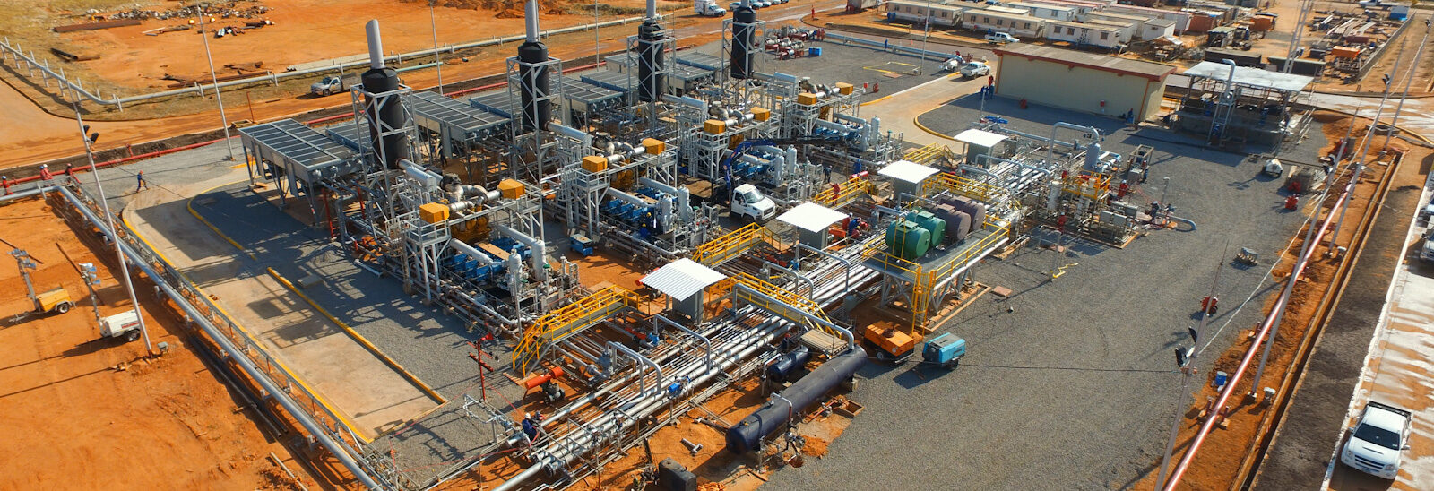 Aerial panoramic view of the infrastructure and foundations of a CH4 Systems engineering plant under development in a rural area.